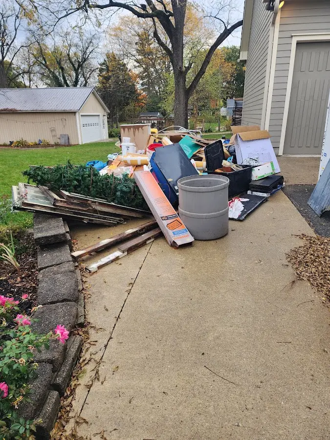 Dumpster being loaded with debris for Estate Cleanout Dumpster Rental in Martinsburg